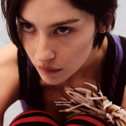 Close-up portrait of Gracie Abrams with text "Daughter From Hell.