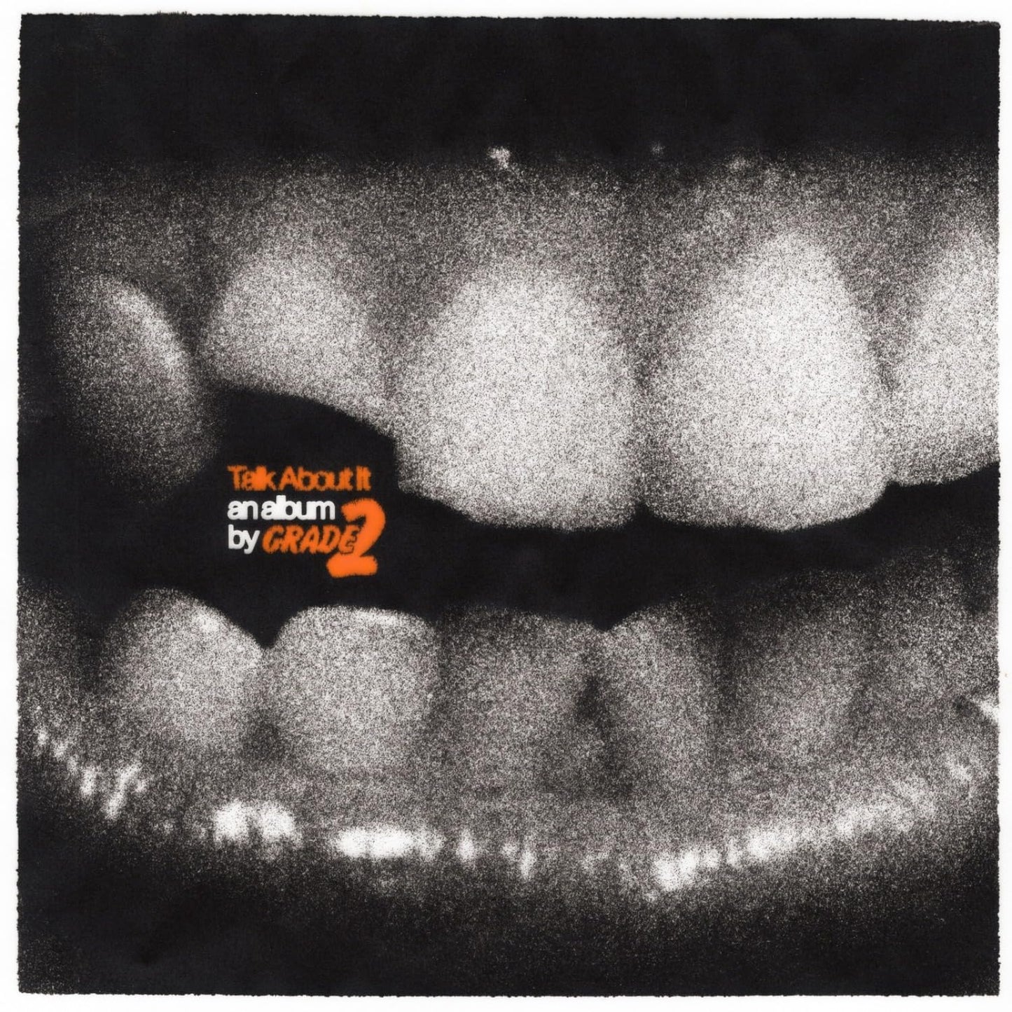 Black and white image of teeth with orange text: "Talk About It" by Grade 2.