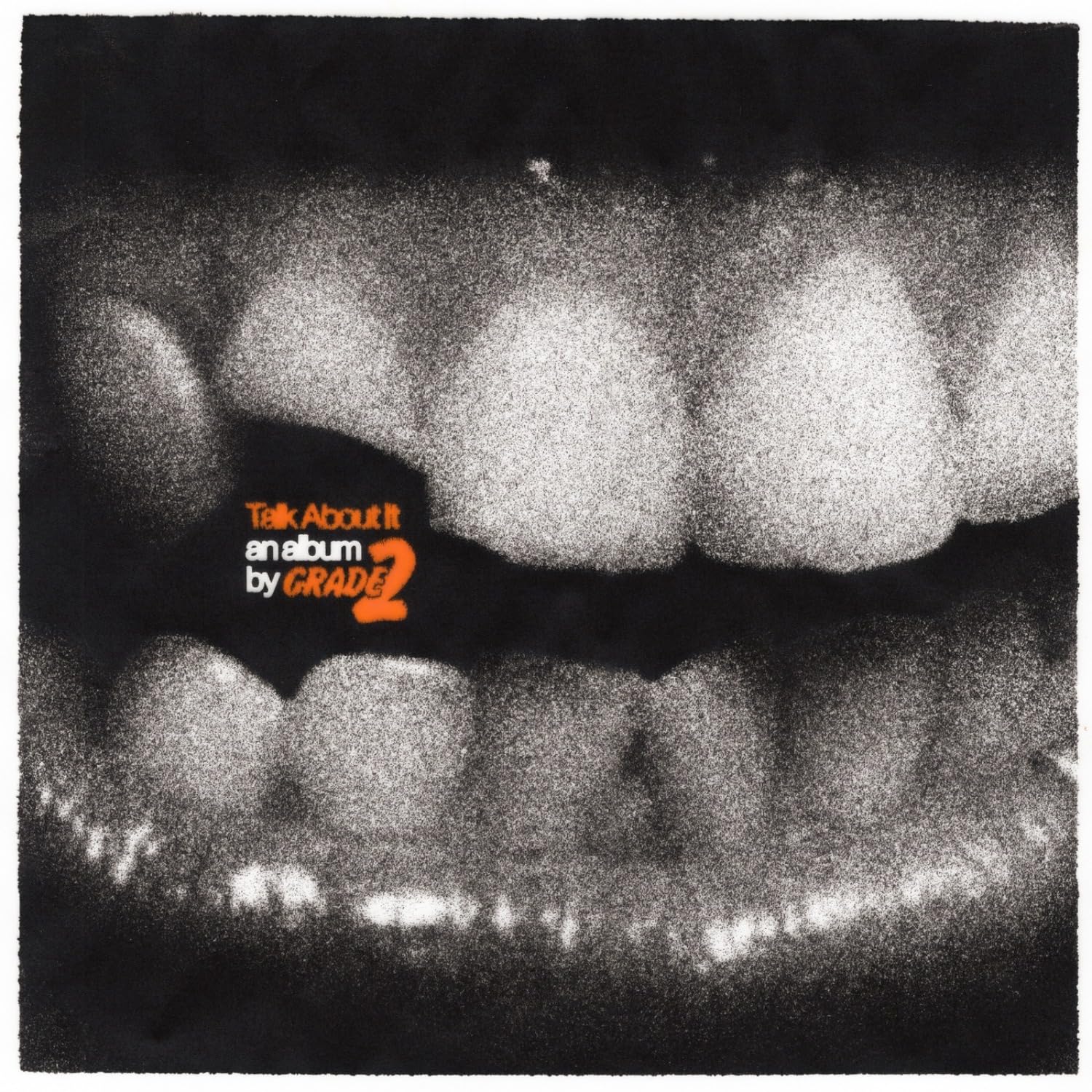 Black and white image of teeth with orange text: "Talk About It" by Grade 2.