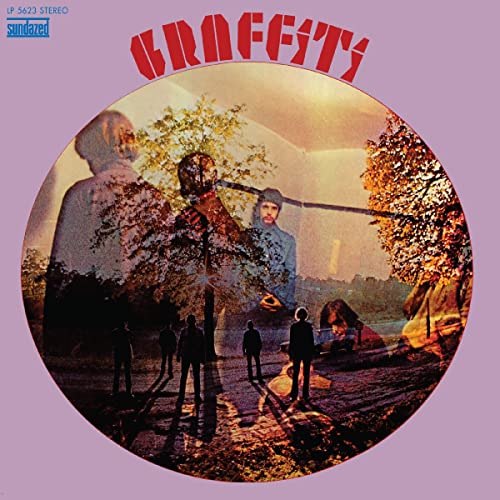 Album cover with surreal landscape, figures, and large red “Graffiti” text.