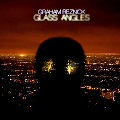 Album cover: dark silhouette against a city lights backdrop.
