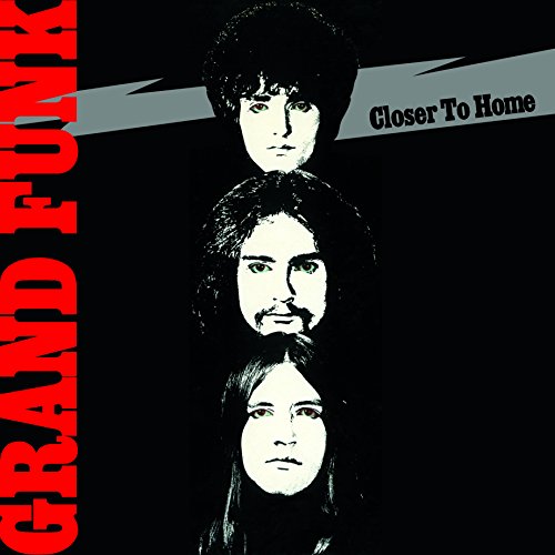 Album cover with three stacked portraits of band members against a black background.