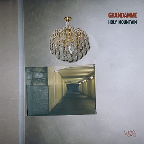 CD cover with a chandelier above a tunnel opening.