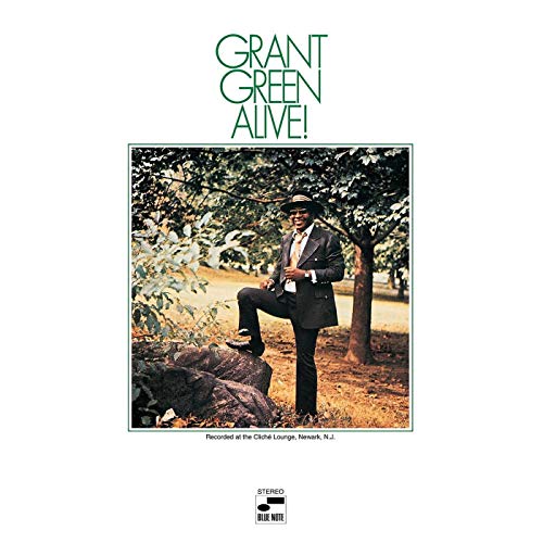 Grant Green album cover: a suited man poses outdoors under trees.