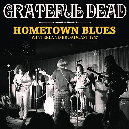 Black and white photo of The Grateful Dead performing on stage.