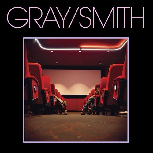 Album cover: empty movie theater seats with a dog in the aisle.