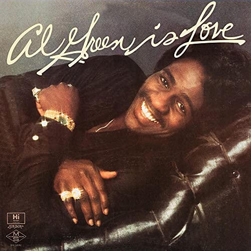 Al Green album cover: smiling man in gold jewelry on a couch.