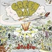 "Album cover art for Green Day's 'Dookie' featuring a cartoon plane crashing into a crowd."