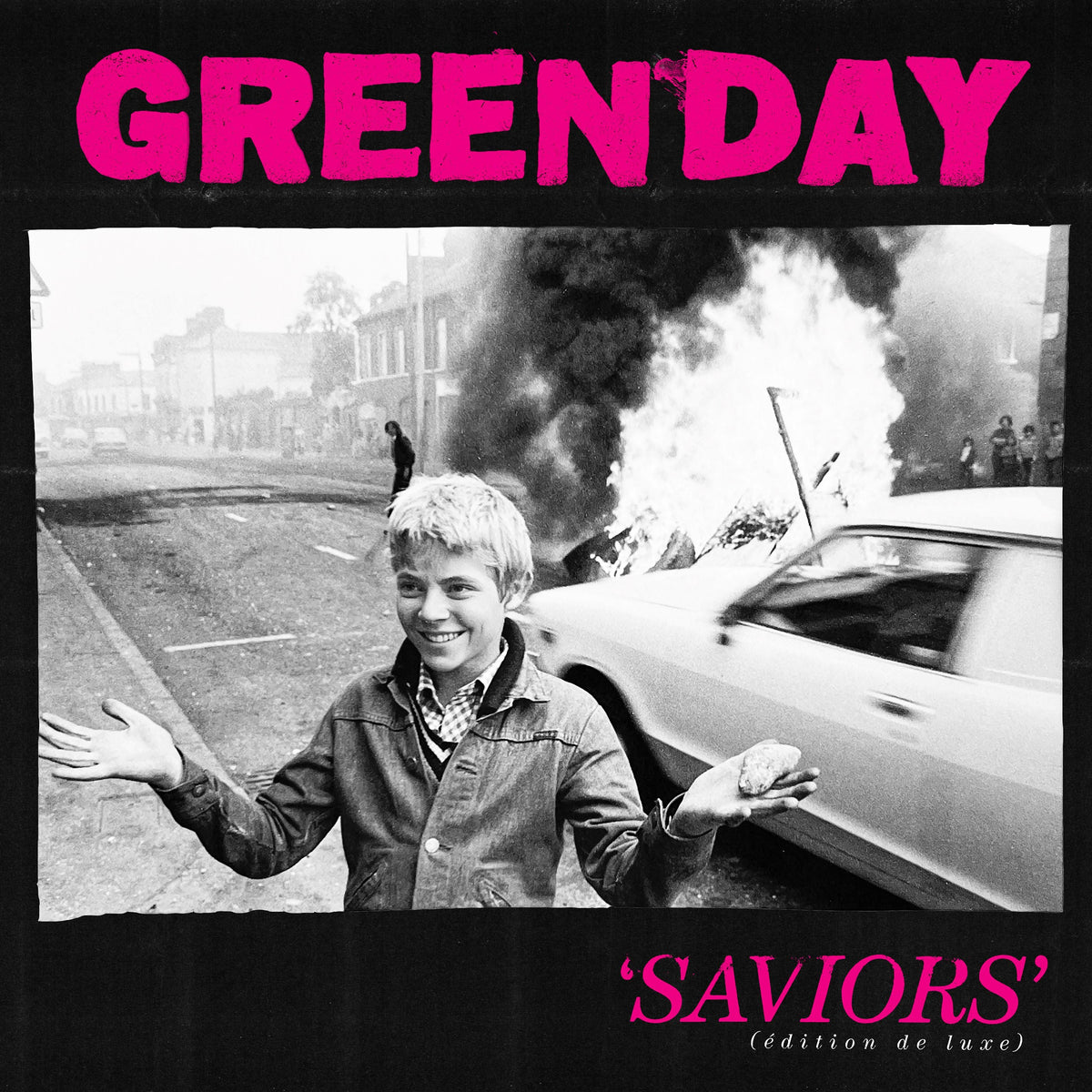 Green Day’s “Saviors” album cover: boy with outstretched arms, burning car.