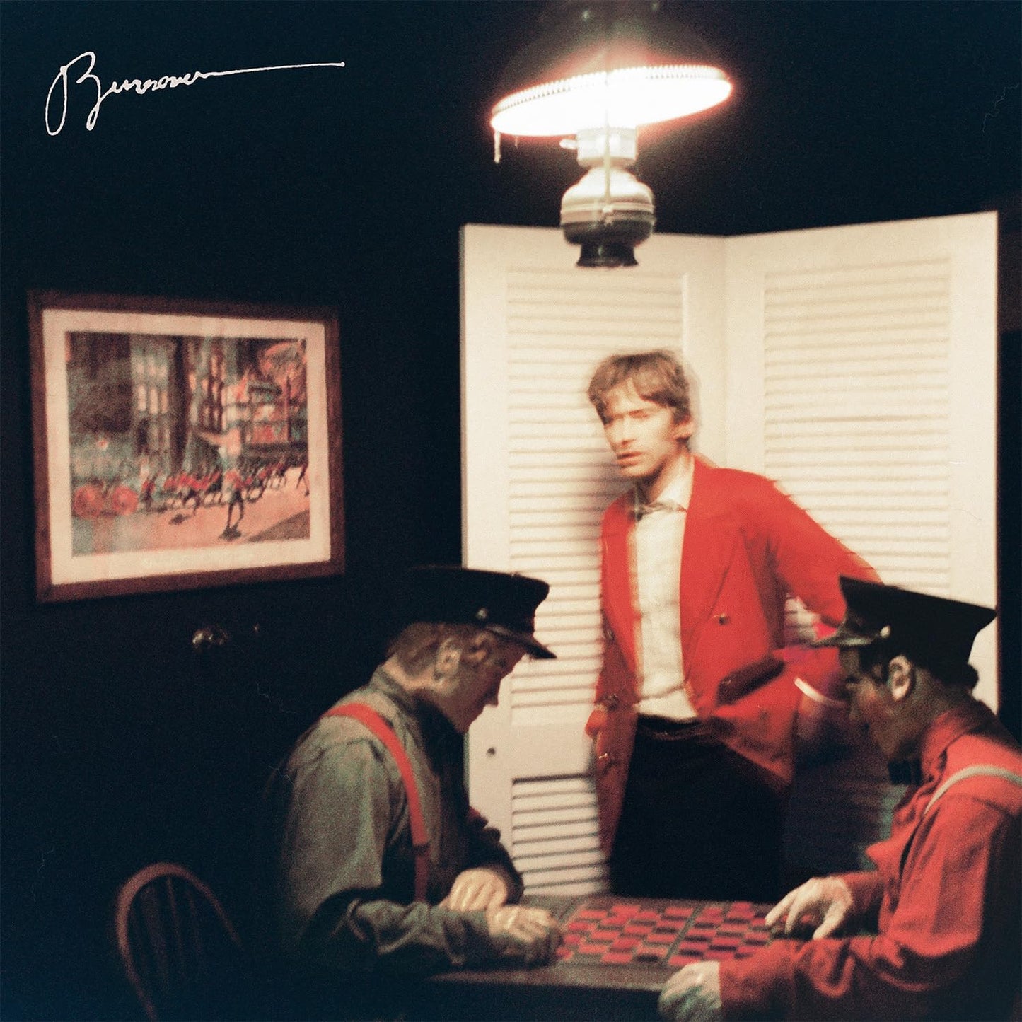 Album cover: man in red with two figures in train conductor hats.