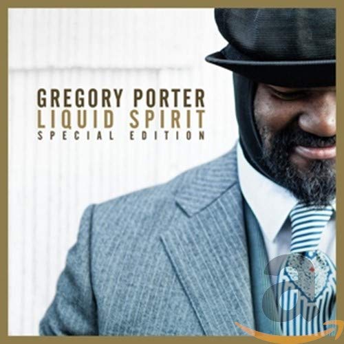 Man in suit and bowler hat on music album cover with text.