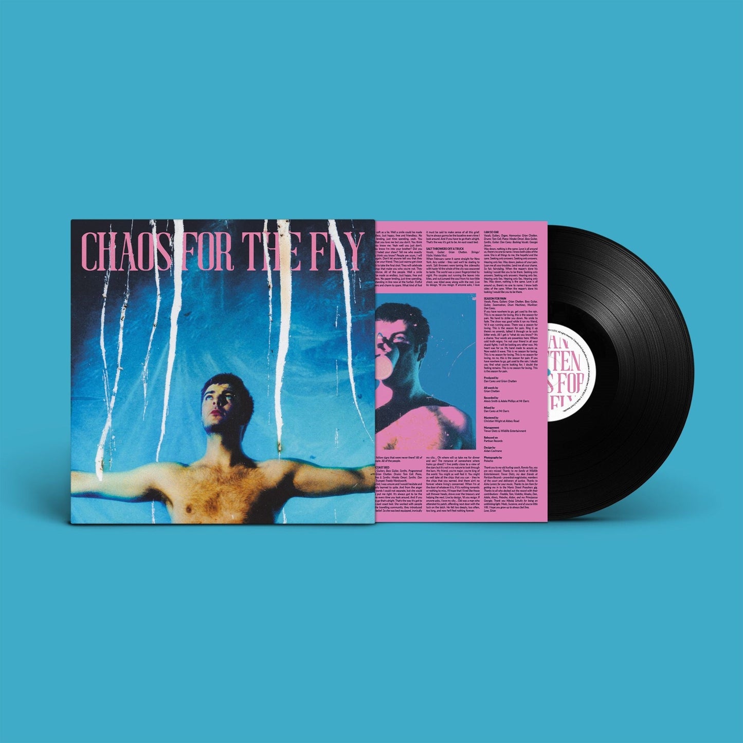 Vinyl record with album cover featuring a portrait and abstract design.