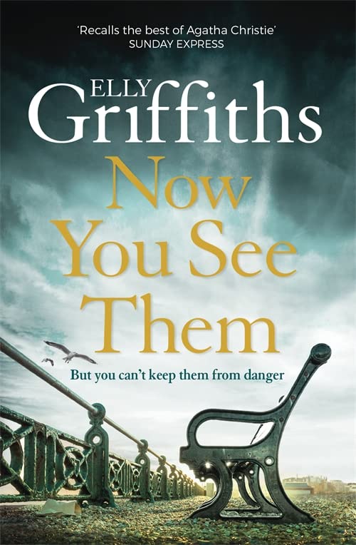 Book cover for Now You See Them by Elly Griffiths featuring a seaside bench.