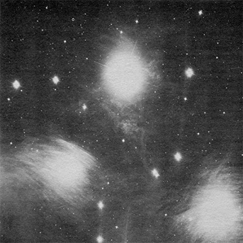 Black and white image of a star field with nebulous, glowing patches.