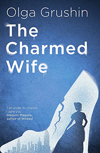 Book cover: “The Charmed Wife” with a blue background and a silhouetted shoe.