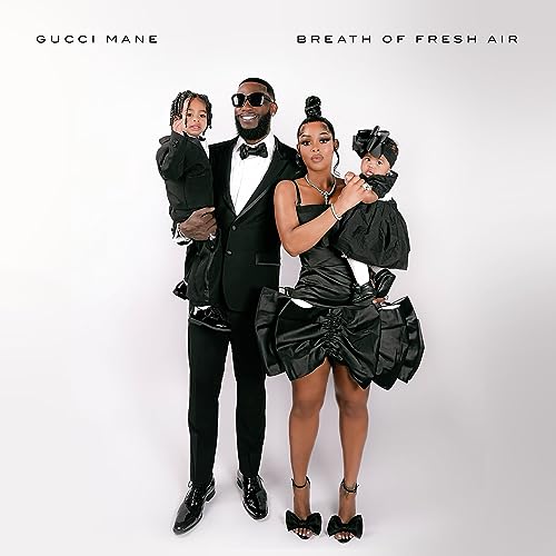 Gucci Mane with family, all in formal black attire, album cover.