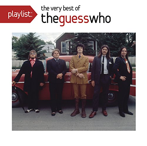 The Guess Who band members posing in suits by a red car.