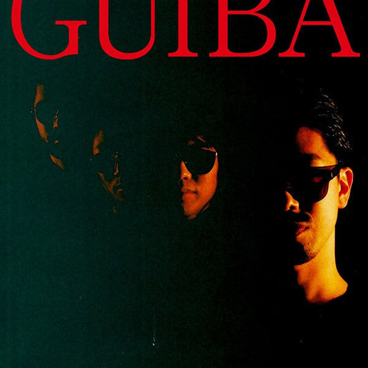 Album cover for “Guiba” featuring a shadowed portrait of a person in sunglasses.