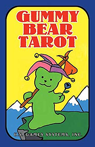 Gummy bear with staff and flower, standing before mountains, on tarot deck cover.