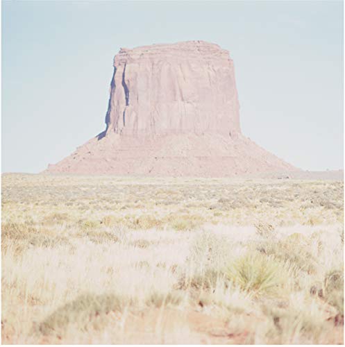 Butte formation in a desert landscape, vinyl record cover art.