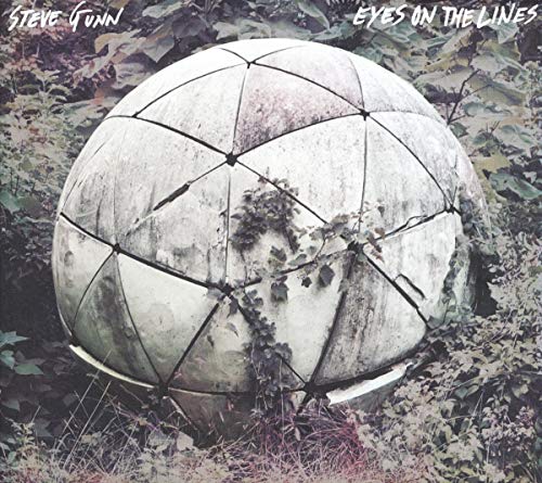 A large, weathered geodesic sphere sits amidst overgrown foliage on this album cover.