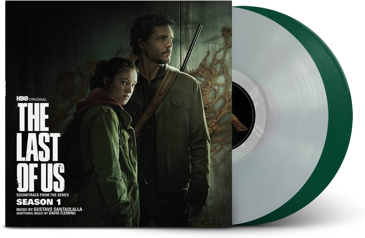 "Vinyl record with green sleeve and transparent disk, featuring 'The Last of Us' cover art."