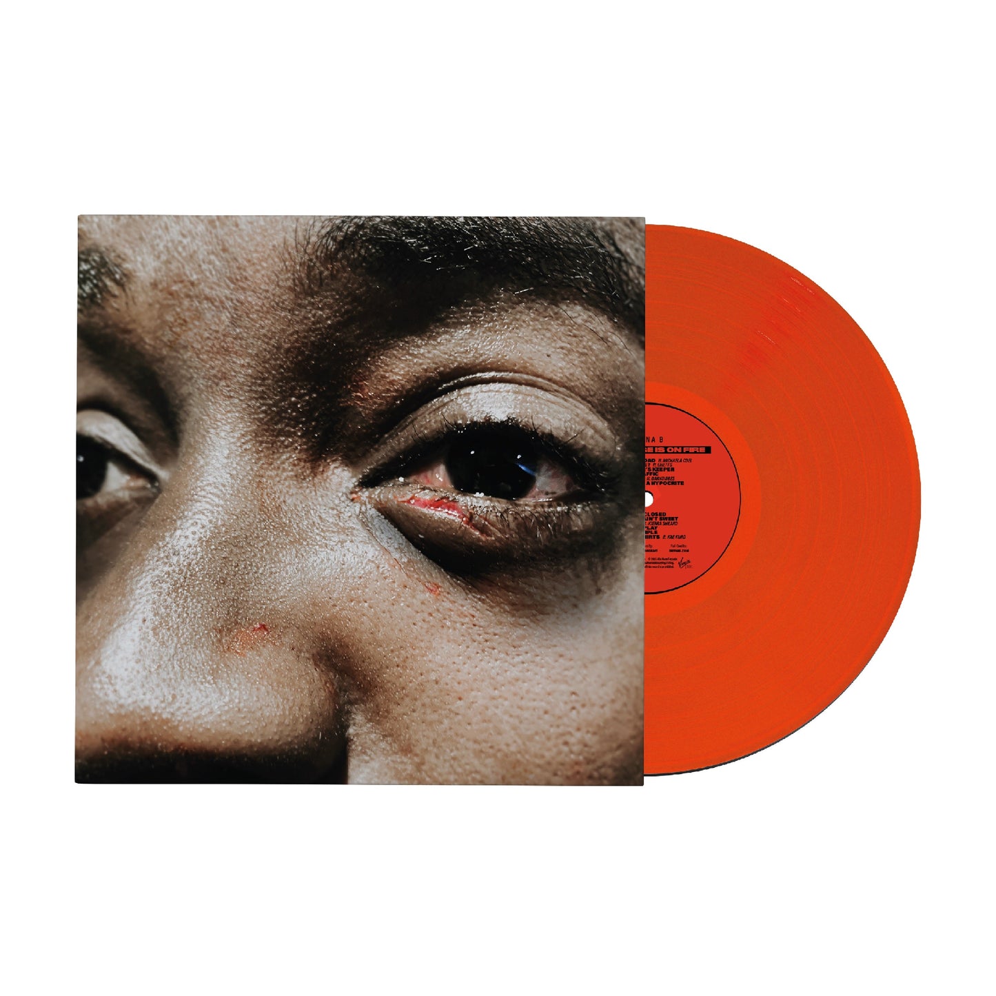 "Red vinyl record with album cover featuring a close-up of a person's face."