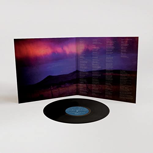 Vinyl record with open gatefold sleeve showing a landscape and text.