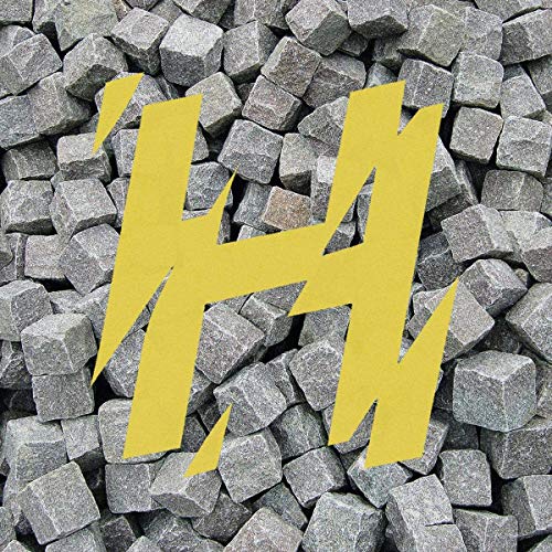 The image depicts a pile of small, gray, cube-shaped objects. Alt text: Gray cubes with a large yellow "H" in the center.