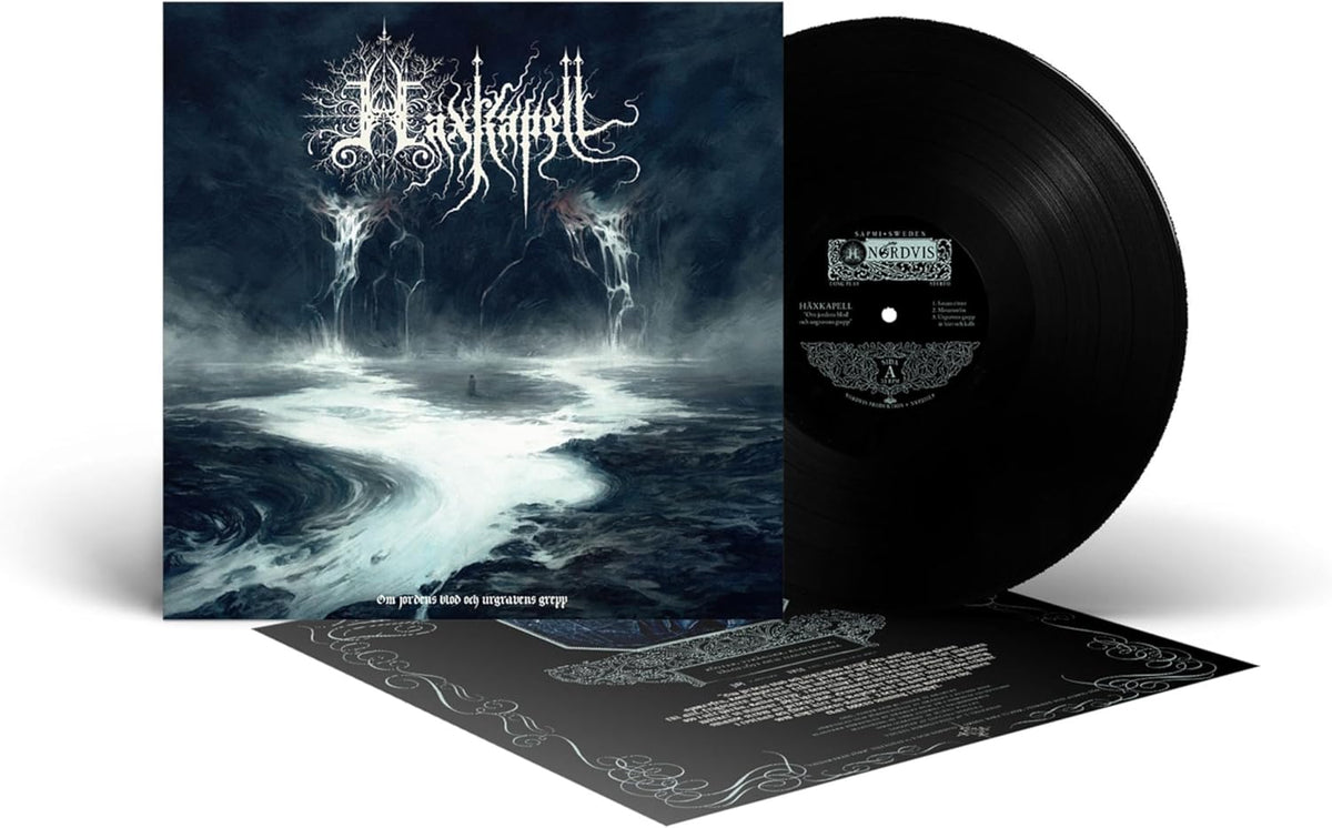 Vinyl record and album cover with dark, stormy landscape imagery.