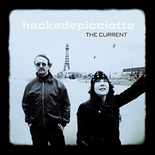 Black and white album cover featuring two people on a beach.