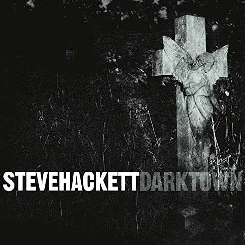 Dark album cover featuring a stone cross and the artist’s name.