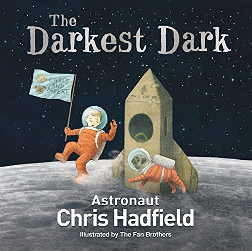 Children in spacesuits on the moon with a cardboard rocket.