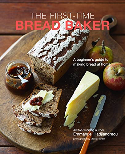 Book cover with loaf of bread, jam, cheese, and fruit on wood.