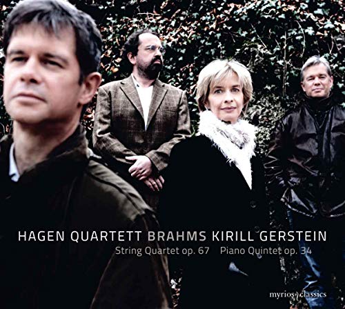 Four musicians stand before a leafy green hedge on a CD cover.