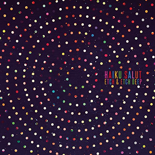 Album cover with multicolored dots arranged in concentric circles on a dark purple background.