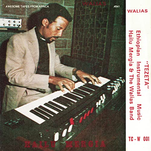 Hailu Mergia playing an electronic keyboard on album cover, red text.