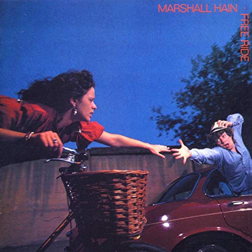 Album cover: woman and man near a car and bicycle.