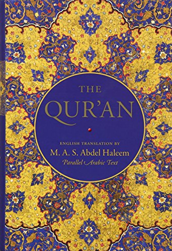Book cover for The Qur'an with blue and gold ornate floral patterns.