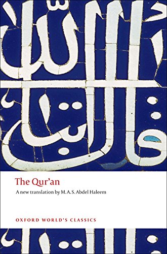 Book cover of The Qur'an with white Arabic calligraphy on a blue tiled background.