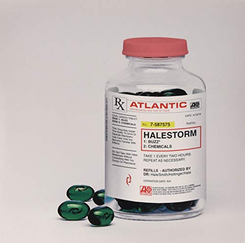 A prescription bottle with a Halestorm label and green pills on a white surface.
