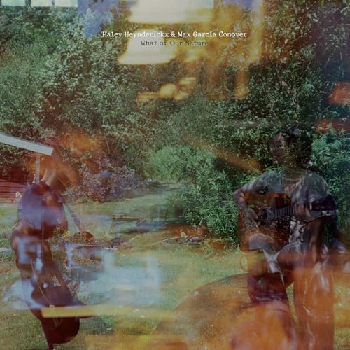 CD cover: two figures in a lush, blurred garden scene.