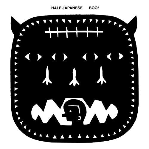 Black and white illustration of a monster face with sharp teeth.