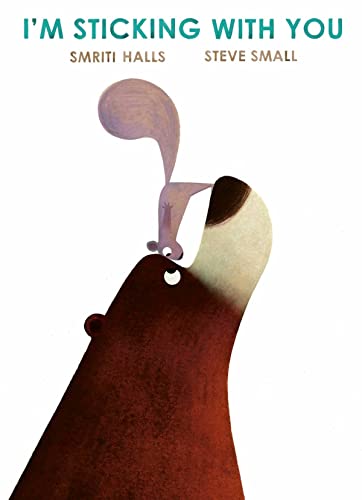 A small squirrel stands on the nose of a large brown bear.