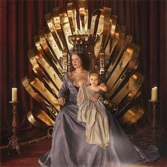 Halsey sits on a golden throne holding a baby, next to a black vinyl record.