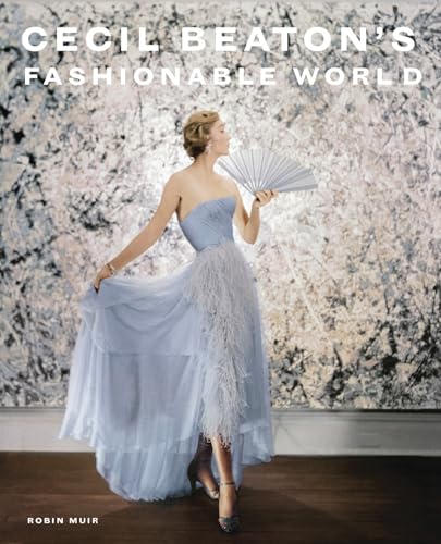 A woman in a blue feathered gown holds a fan against an abstract background.