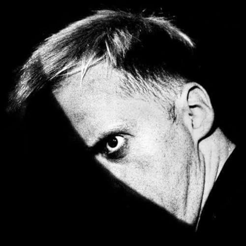 Black and white close-up of a man’s face, looking intensely at the viewer.
