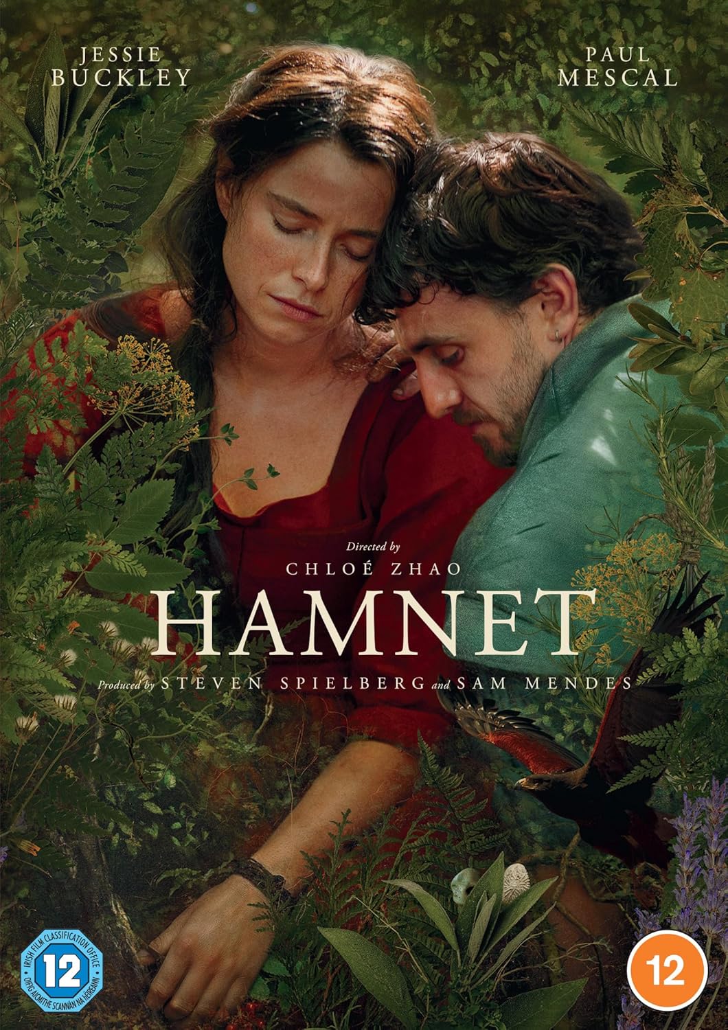 Jessie Buckley and Paul Mescal embrace amidst lush greenery on the Hamnet DVD cover.