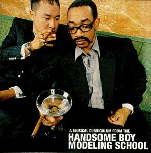 Two men in suits, with a martini glass and cigar.
