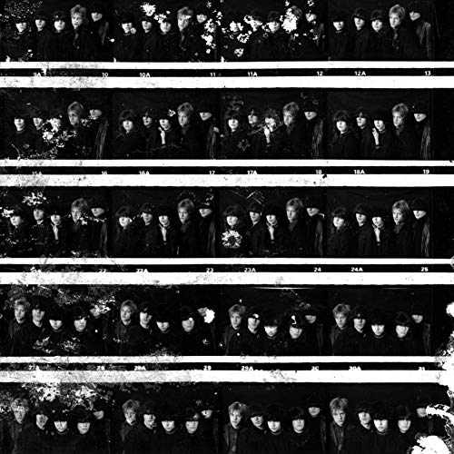 Black and white image of multiple strips of film showing a band in dark clothing.